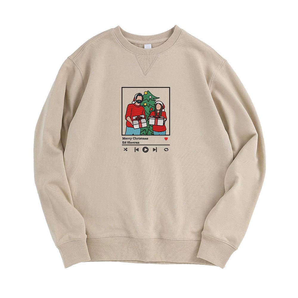 Custom embroidered jumper in sand colorway laid flat with photo embroidery detail on the chest